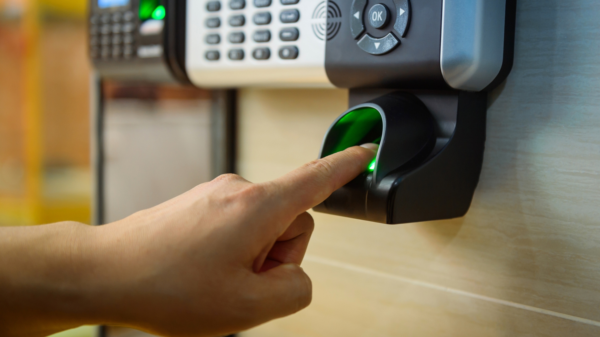 A user scanning finger on a fingerprint door lock
