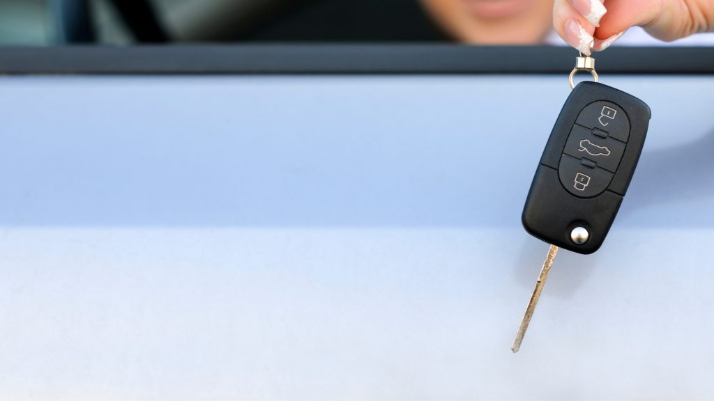 A driver handing over her transponder car key