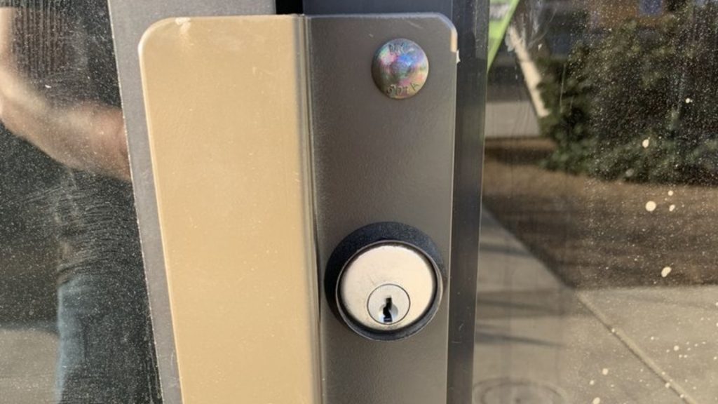 A latch guard on an outswing door