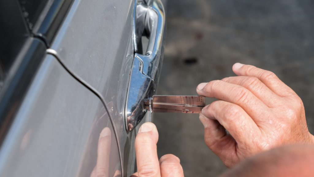 A locksmith performing a car lockout service
