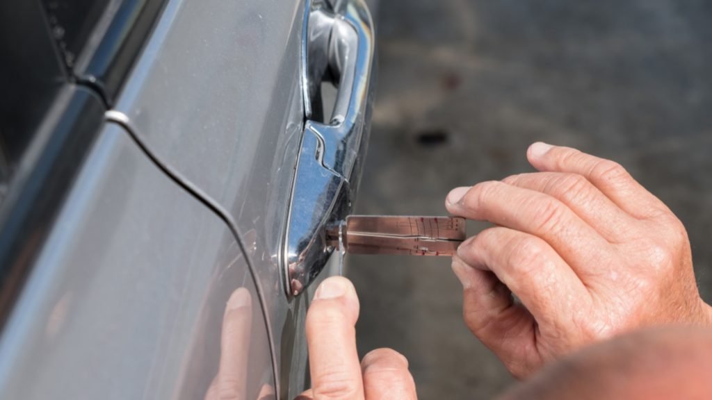 A locksmith performing a car lockout service