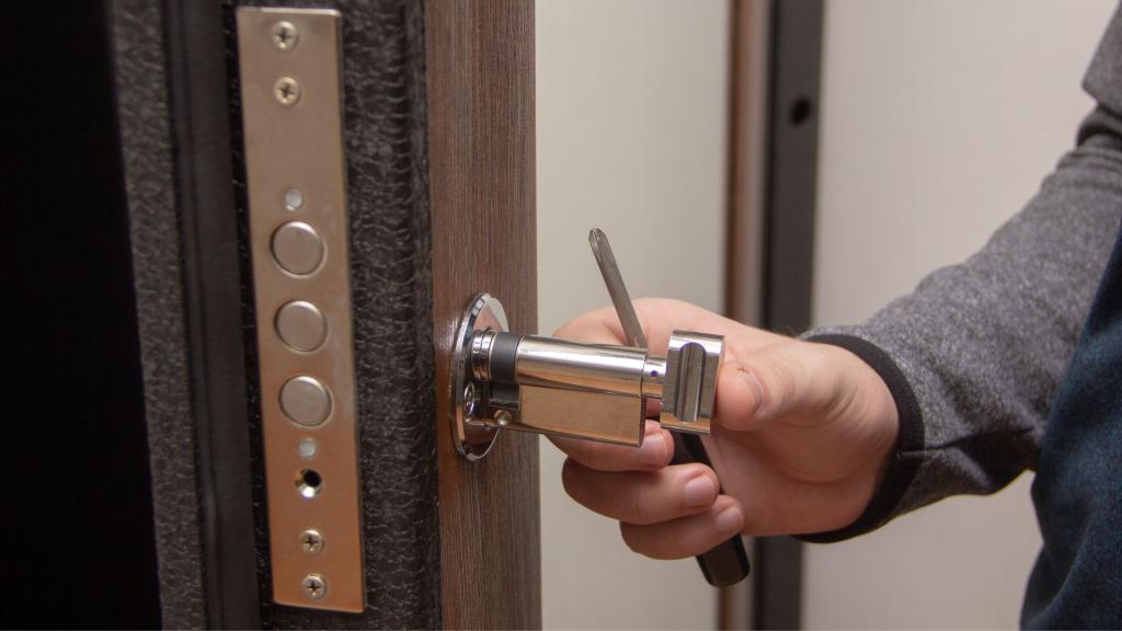 Technician rekeying a front door lock cylinder for improved home security