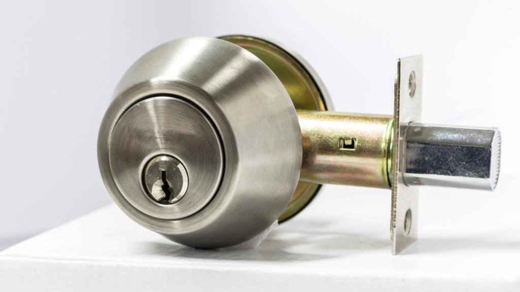 Close-up view of a residential deadbolt with a solid metal bolt for stronger door security